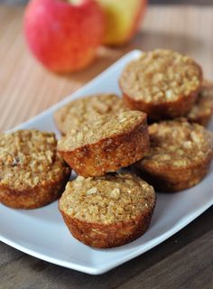 some muffins are on a white plate and ready to be eaten