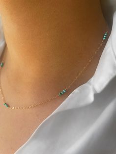 "Tiny turquoise stones interspersed with a delicate gold chsin. These stones, originating in Arizona, are truly beautiful and the colour wonderfully vivid. The simplicity of the design makes this a truly delicate piece, perfect for gifting to yourself or those you love. Turquoise is the birthstone of the December born. The necklace pictured is 18\" but custom lengths are available on request. Available in 9ct gold, gold filled, rose gold filled and sterling silver. Each piece comes beautifully gift wrapped. Turquoise, the captivating sea-green stone of the ancients, represents wisdom, tranquility, protection, good fortune, and hope. Ancient peoples believed in its profound power to protect, as well as its tranquil energy and its association with enduring love. Gold filled is made by heat a Gold Turquoise Necklace, Dainty Turquoise Jewelry In 14k Gold Filled, Dainty 14k Gold-filled Turquoise Jewelry, Dainty 14k Gold Filled Turquoise Jewelry, Dainty Turquoise Necklace With Delicate Chain, Dainty Turquoise Necklace With Tiny Beads, Dainty Turquoise Necklace With Tiny Beads As Gift, December Born, Arizona Turquoise