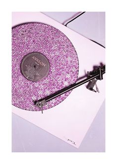 the record player is covered in purple glitter