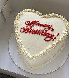 a heart shaped cake with the words happy birthday written on it