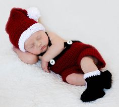 a newborn baby wearing a santa hat and diaper