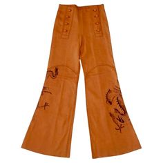 Vintage 1970s handmade North Beach Leather deerskin pants in a sailor-pant style, flared bell bottom fit. Whipstitch construction, 8-button front. Dragon art on both legs, signed "Gary". These are in good condition, especially for a pair of this age from North Beach Leather. The leather is incredibly soft and supple. There are what appears to be a small scratch near the center seam in the back, as well as a number of small marks and stains, shown in the photos. Tagged a size 8. Measurements are The Shining Twins, 70s Pants, Sailor Pants, Jean Vintage, North Beach, Couture Vintage, Deer Skin, Pant Style, The Shining