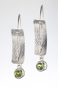 Silver & Stone Earrings - Sterling silver, concave, rectangular earrings pierced by sterling silver ear wires.  A 6mm-round, faceted peridot is bezel-set and dangles from the bottom of the earrings. The sterling-silver rectangles are textured with roller printing. Each pair of earrings is handmade; the texture will vary. Silver Dangle Peridot Earrings, Silver Peridot Dangle Earrings, Pmc Earrings, Roller Printing, Solder Jewelry, Gecko Terrarium, Printed Texture, Art Jewelry Earrings, Rectangular Earrings