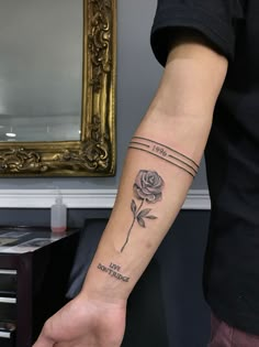 a person with a rose tattoo on their arm