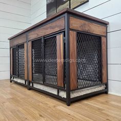 a dog house made out of wood and metal on the floor in front of a white wall