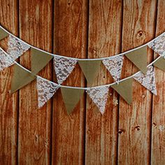 white lace buntings hanging from a wooden wall