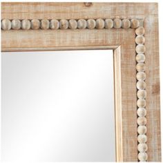 a mirror that is made out of wood and has shells on the edge of it