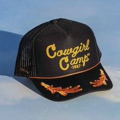 Inspired by cowgirl culture, our Black Cowgirl Camp Captain Hat has a mesh back for breathability, embroidered details, and features hand-drawn artwork by artist Paige Johnson. Western Style Adjustable Trucker Hat 5-panel, Adjustable Western Style Trucker Hat, Adjustable Western 5-panel Trucker Hat, Western Trucker Hat For Festivals, Embroidered Adjustable Trucker Hat For Outdoor, Country Style Trucker Hat For Festival, Western Curved Brim Trucker Hat For Festivals, Western Style 5-panel Trucker Hat For Rodeo, Country Style Adjustable Trucker Hat For Festivals