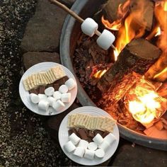 marshmallows and chocolate are being cooked over an open fire