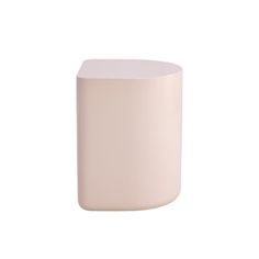 a small white vase sitting on top of a table