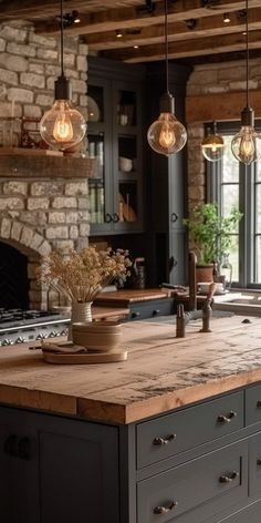 a kitchen island with lights hanging from it's ceiling and an oven in the background