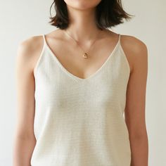 Sleeveless linen knit tank, perfectly worn in shirt with high quality stitching. Feels soft to the touch and is perfect for summer. Model is wearing MINUSEY ONE SIZE. Please allow 5-12 days shipping when in restocking.* MINUSEY ONE SIZE = EU 34-38, US 2-6* 60% Linen / 20% Rayon / 20% Acrylic* Dry clean* Made in Korea - Model Height: 171cm/5'7" (US 2, EU 34) Versatile V-neck Knit Top For Summer, Minimalist Summer Tank Top For Everyday, Summer V-neck Knit Top For Loungewear, Summer Layering Tank Top, Summer Tank Top For Layering, Chic Summer Knit Top For Everyday, Effortless Summer Layering Tank Top, Effortless Tank Top For Summer Layering, Summer Layering Knit Top