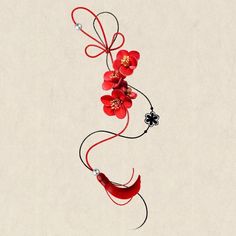 a red flower is hanging from a string