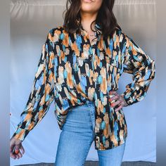 This Abstract Printed Blouse Is Sure To Up Your Office Look! -Collared -Front Button Closure -Breast Pocket -Long Sleeves -Relaxed Fit Trendy Orange Blouse With Button Closure, Fall Orange Blouse With Button Closure, Printed Relaxed Fit Button-up Blouse, Affordable Graphic Print Button-up Blouse, Patterned Button-up Top With Abstract Print, Multicolor Button-up Blouse With Button Closure, Royal Blue Top, Pink Sleeveless Blouse, Tie Sleeve Blouse