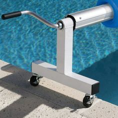 a pool is shown with a hand rail attached to the side of it and water in the background