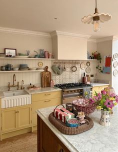 a kitchen filled with lots of counter top space and decor on the wall above it