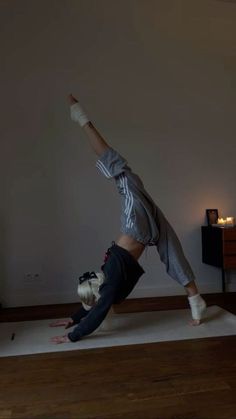 a person doing a handstand on a rug