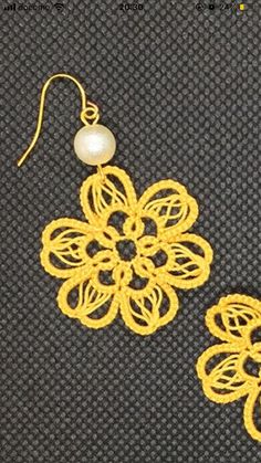 two pairs of yellow crochet earrings with pearls