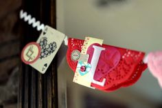 two pieces of paper are hanging on a clothes line with tags attached to the clothesline