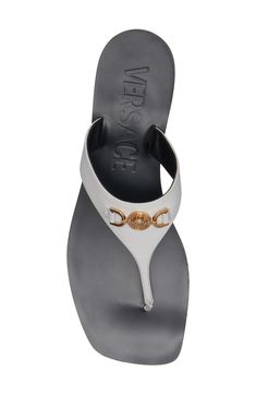 Versace's Medusa symbol was developed in 1995 into the iconic hardware that's featured on the strap of this leather flip-flop. Leather upper, lining and sole Made in Italy Designer Shoes Luxury Leather Flip Flops With Single Toe Strap, Luxury Leather Open Toe Flip Flops, Luxury Leather Flip Flops For Beach, Luxury Toe Post Sandals, Designer Leather Sandals With Logo, Elegant Leather Flip Flops With Branded Insole, Designer Leather Flip Flops For Beach, Designer Leather Flip Flops For The Beach, Elegant Leather Sandals With Logo