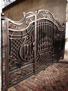 an ornate iron gate on the side of a building