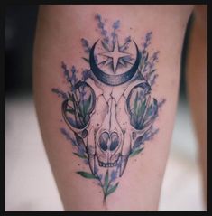 a skull with flowers and a star on it's head is shown in this tattoo design