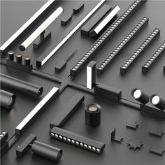 an assortment of black and silver objects on a gray surface with white trimmings