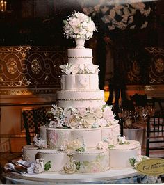 a large white wedding cake sitting on top of a table