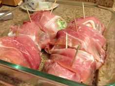 several pieces of meat in a glass dish with toothpicks