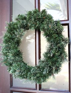 a wreath is hanging on the front door