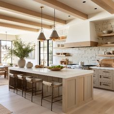 a large kitchen with wooden floors and white walls