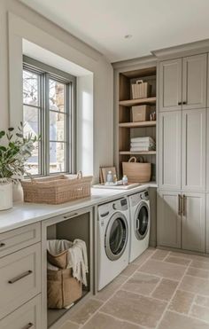 a washer and dryer in a room with lots of cupboards on the wall