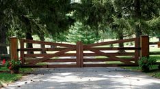 a wooden gate in the middle of a park