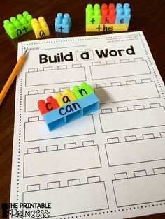 a printable build a word game with legos and pencils next to it