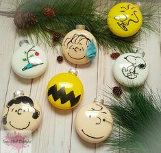 christmas ornaments with hand drawn faces on them