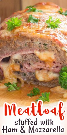 meatloaf stuffed with ham and mozzarella on a cutting board next to parsley