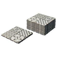 a stack of black and white tiles sitting on top of each other