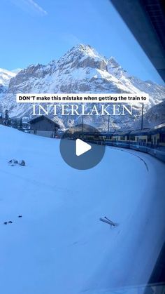 a train traveling down tracks next to snow covered mountains and trees with text overlay that reads, don't make this track when getting the train to interlake