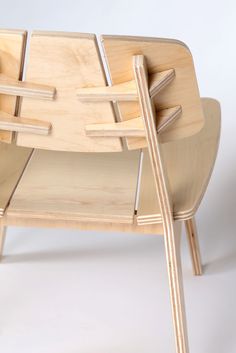 a chair made out of plywood and wood with two legs that are bent to the side