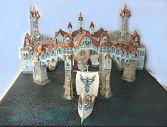 a model of a castle with a boat on the ground