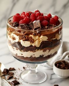 a dessert dish with chocolate and raspberries in it