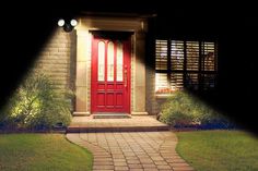 a red door in front of a brick house