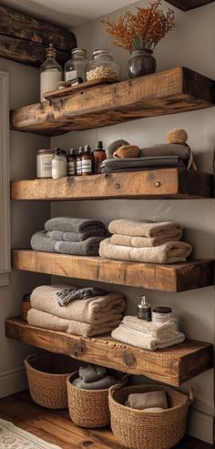 the shelves in this bathroom are made out of wooden planks and have baskets on them