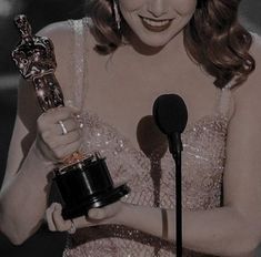 the actress is holding her oscar for best supporting actress in a musical motion or tv series