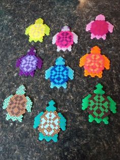 six different colored turtle shaped beads on a table