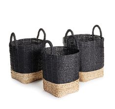 three black and beige baskets with handles on each side, one is holding two straw bags