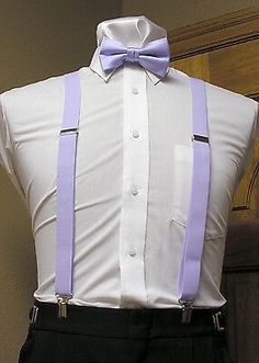 a white shirt with purple suspenders and a bow tie