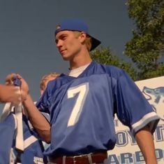 a baseball player is holding onto his jersey