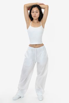 These lightweight nylon pants feature an extra wide, baggy straight leg fit. They feature 2 side pockets, 1 back pocket with velcro closure, and an elastic waistband with drawcord for an adjustable fit. These pants are unlined, making them super compact for traveling and versatile for different climates and weather needs. This fabric is great for maintaining body heat making these pants ideal for warm-ups and more. Please note: Lighter colors are slightly see-through! Try pairing with a bodysuit Women In White, Pant For Women, Nylon Pants, Wide Leg Pant, Body Heat, Baggy Fits, Fashion Pants, Wide Leg Pants, Two Piece Pant Set