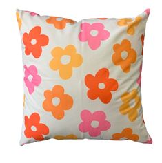 an orange and pink flowered pillow on a white background with the word love written across it